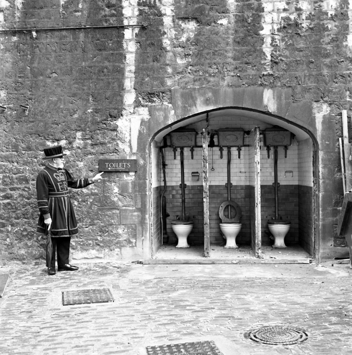 Yeoman by a sign to the toilets